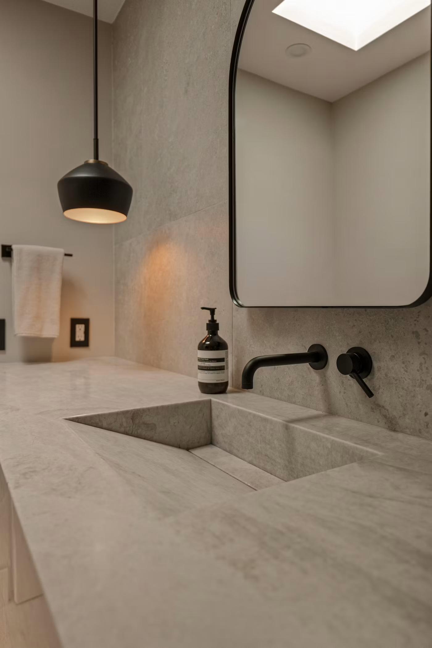 Bathroom vanity with view toward walk-in shower and toilet