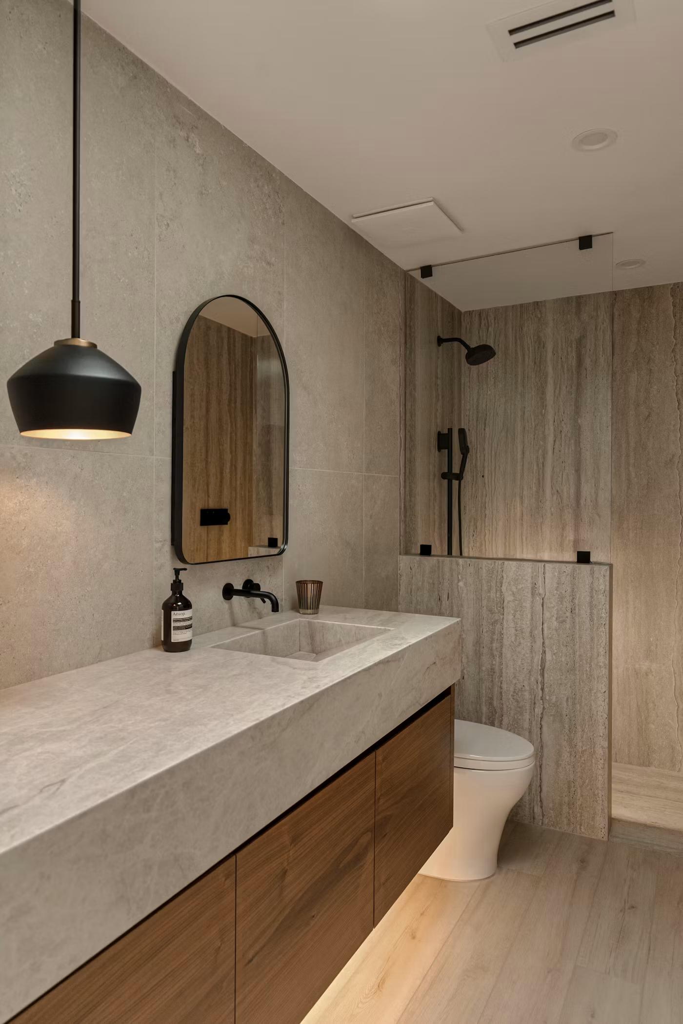 Full bathroom with double vanity, toilet, and glass shower