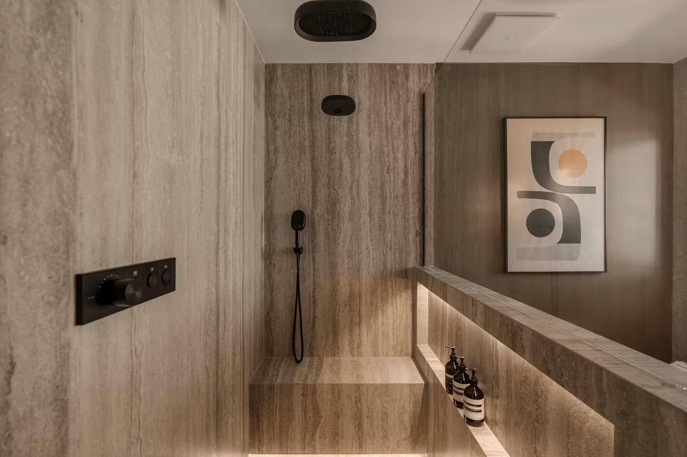 Travertine walk-in shower with ceiling-mounted rain head